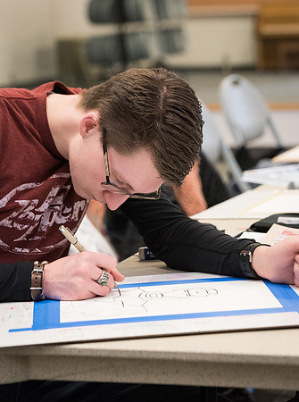 Students work on paintings in Sally Ellis' watercolor class.