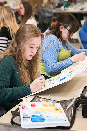 Students work on paintings in Sally Ellis' watercolor class.