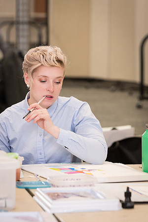 Students work on paintings in Sally Ellis' watercolor class.