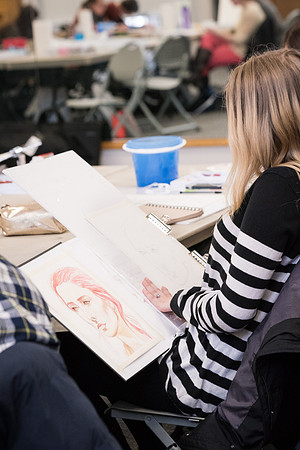 Students work on paintings in Sally Ellis' watercolor class.
