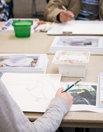 Students work on paintings in Sally Ellis' watercolor class.
