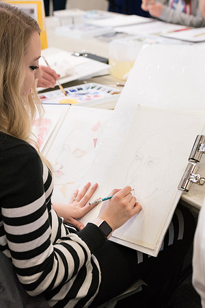 Students work on paintings in Sally Ellis' watercolor class.