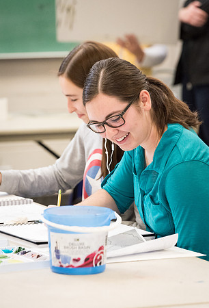 Students work on paintings in Sally Ellis' watercolor class.