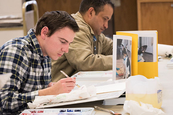 Students work on paintings in Sally Ellis' watercolor class.