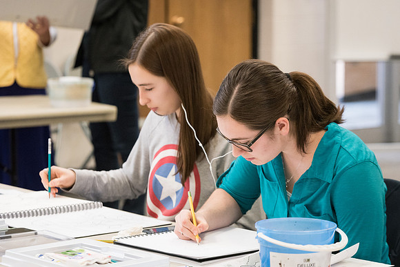 Students work on paintings in Sally Ellis' watercolor class.