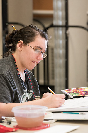 Students work on paintings in Sally Ellis' watercolor class.