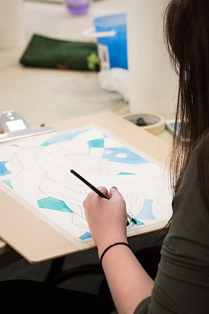 Students work on paintings in Sally Ellis' watercolor class.