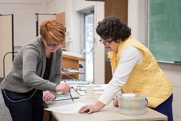 Students work on paintings in Sally Ellis' watercolor class.