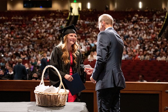 Graduates walk across the stage at the BYU-Idaho Center as they accept their diplomas for Agriculture and Life Science.