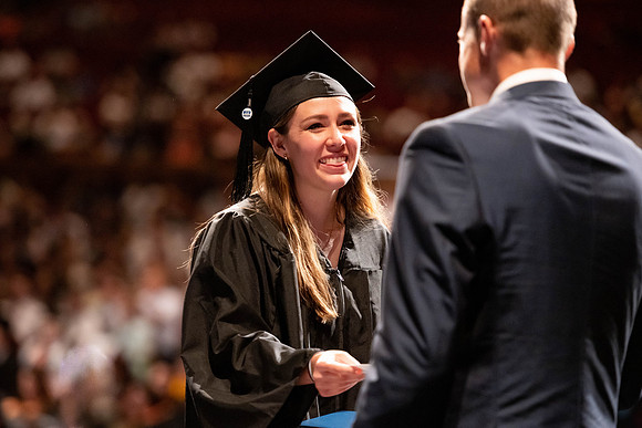 Graduates walk across the stage at the BYU-Idaho Center as they accept their diplomas for Agriculture and Life Science.