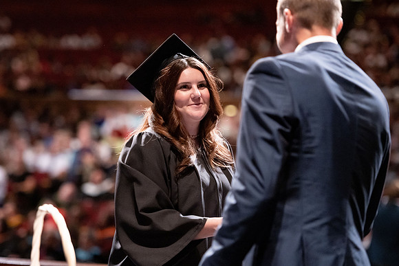 Graduates walk across the stage at the BYU-Idaho Center as they accept their diplomas for Agriculture and Life Science.