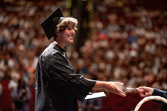 Graduates walk across the stage at the BYU-Idaho Center as they accept their diplomas for Agriculture and Life Science.