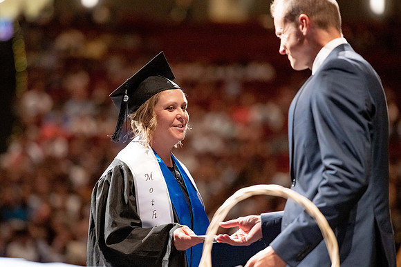 Graduates walk across the stage at the BYU-Idaho Center as they accept their diplomas for Agriculture and Life Science.