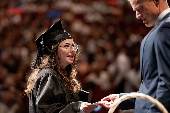 Graduates walk across the stage at the BYU-Idaho Center as they accept their diplomas for Agriculture and Life Science.