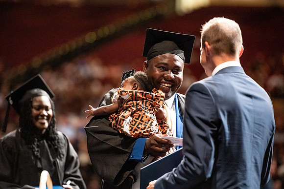 Graduates walk across the stage at the BYU-Idaho Center as they accept their diplomas for Agriculture and Life Science.