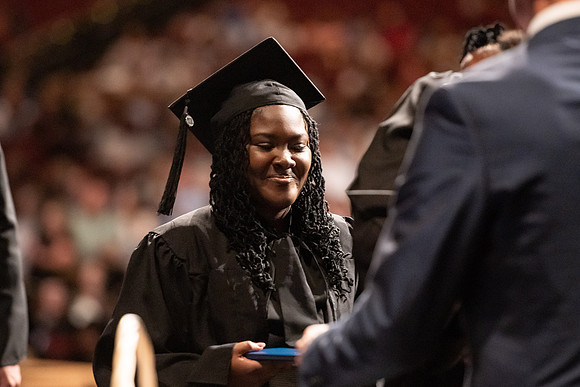 Graduates walk across the stage at the BYU-Idaho Center as they accept their diplomas for Agriculture and Life Science.