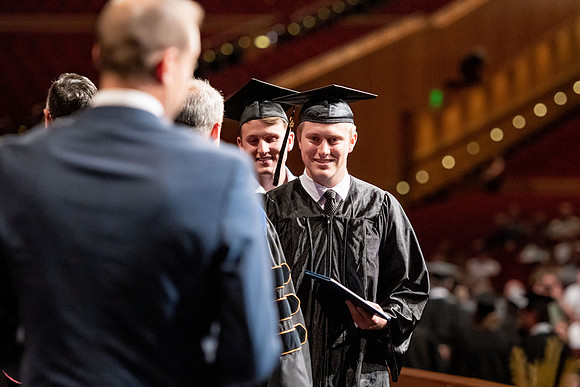 Graduates walk across the stage at the BYU-Idaho Center as they accept their diplomas for Agriculture and Life Science.