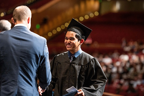 Graduates walk across the stage at the BYU-Idaho Center as they accept their diplomas for Agriculture and Life Science.