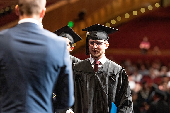 Graduates walk across the stage at the BYU-Idaho Center as they accept their diplomas for Agriculture and Life Science.