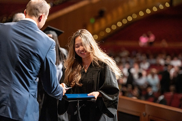 Graduates walk across the stage at the BYU-Idaho Center as they accept their diplomas for Agriculture and Life Science.
