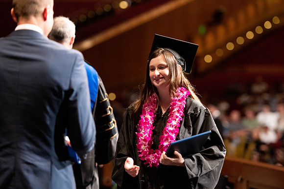 Graduates walk across the stage at the BYU-Idaho Center as they accept their diplomas for Agriculture and Life Science.