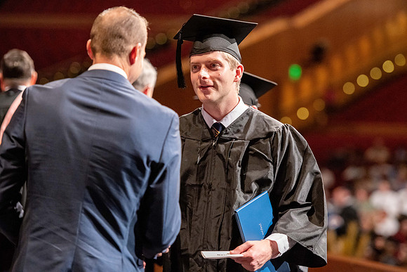 Graduates walk across the stage at the BYU-Idaho Center as they accept their diplomas for Agriculture and Life Science.