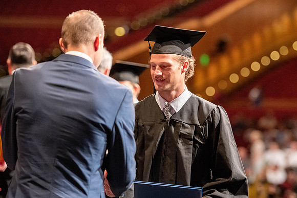 Graduates walk across the stage at the BYU-Idaho Center as they accept their diplomas for Agriculture and Life Science.