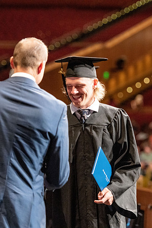 Graduates walk across the stage at the BYU-Idaho Center as they accept their diplomas for Agriculture and Life Science.