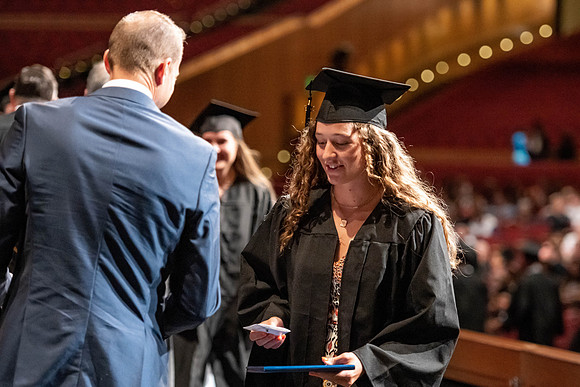 Graduates walk across the stage at the BYU-Idaho Center as they accept their diplomas for Agriculture and Life Science.