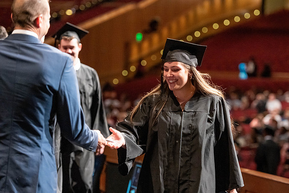 Graduates walk across the stage at the BYU-Idaho Center as they accept their diplomas for Agriculture and Life Science.