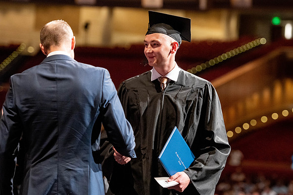 Graduates walk across the stage at the BYU-Idaho Center as they accept their diplomas for Agriculture and Life Science.