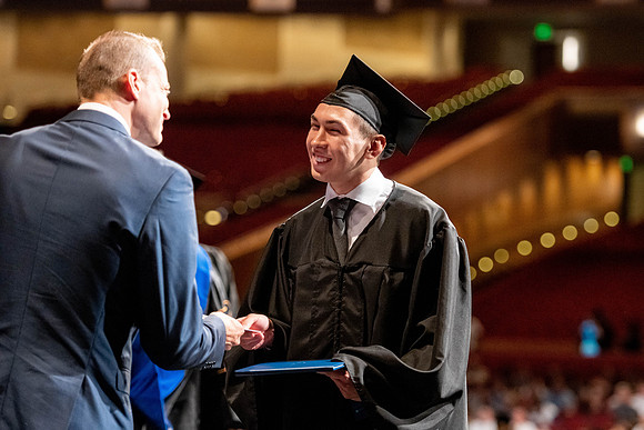 Graduates walk across the stage at the BYU-Idaho Center as they accept their diplomas for Agriculture and Life Science.