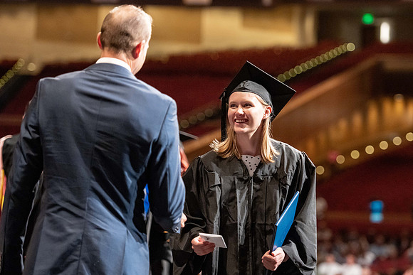 Graduates walk across the stage at the BYU-Idaho Center as they accept their diplomas for Agriculture and Life Science.