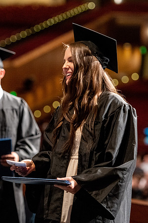 Graduates walk across the stage at the BYU-Idaho Center as they accept their diplomas for Agriculture and Life Science.