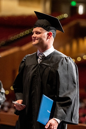 Graduates walk across the stage at the BYU-Idaho Center as they accept their diplomas for Agriculture and Life Science.