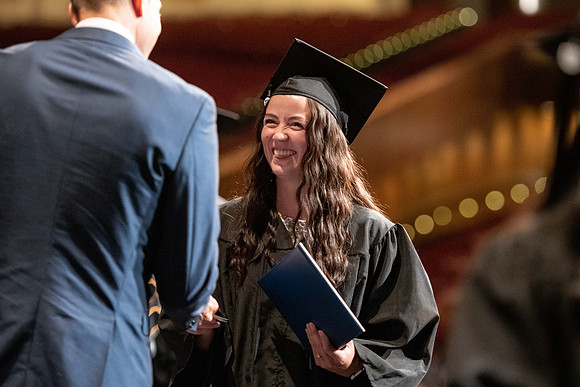 Graduates walk across the stage at the BYU-Idaho Center as they accept their diplomas for Agriculture and Life Science.