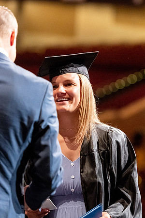 Graduates walk across the stage at the BYU-Idaho Center as they accept their diplomas for Agriculture and Life Science.