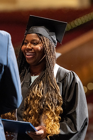 Graduates walk across the stage at the BYU-Idaho Center as they accept their diplomas for Agriculture and Life Science.