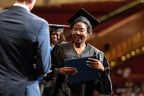 Graduates walk across the stage at the BYU-Idaho Center as they accept their diplomas for Agriculture and Life Science.