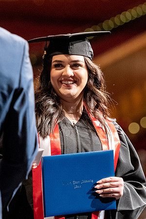 Graduates walk across the stage at the BYU-Idaho Center as they accept their diplomas for Agriculture and Life Science.
