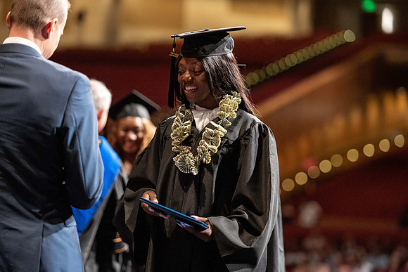 Graduates walk across the stage at the BYU-Idaho Center as they accept their diplomas for Agriculture and Life Science.