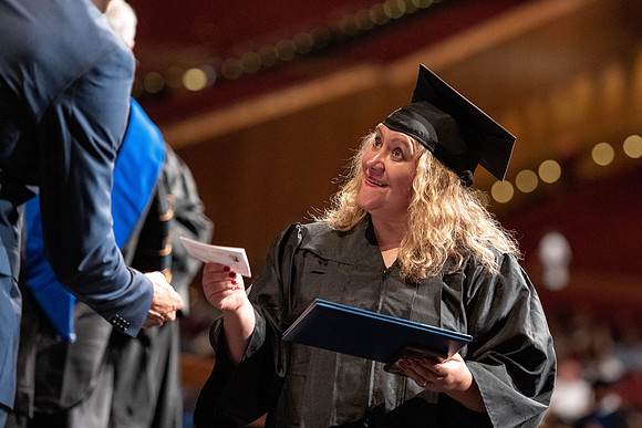 Graduates walk across the stage at the BYU-Idaho Center as they accept their diplomas for Agriculture and Life Science.