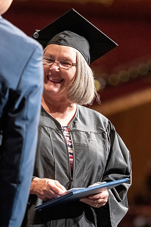 Graduates walk across the stage at the BYU-Idaho Center as they accept their diplomas for Agriculture and Life Science.