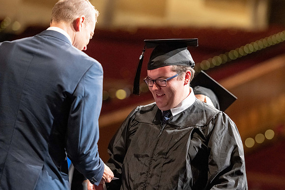 Graduates walk across the stage at the BYU-Idaho Center as they accept their diplomas for Agriculture and Life Science.