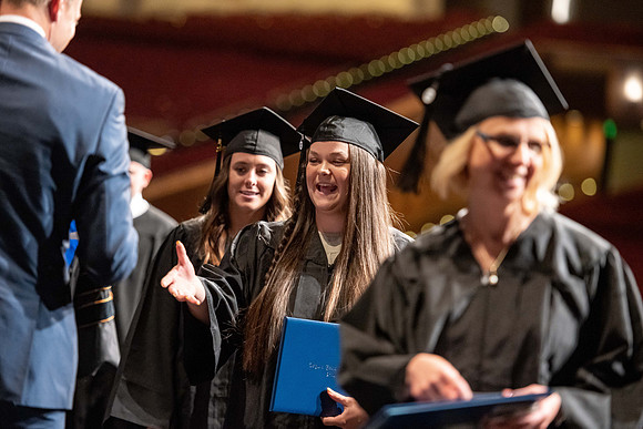 Graduates walk across the stage at the BYU-Idaho Center as they accept their diplomas for Agriculture and Life Science.
