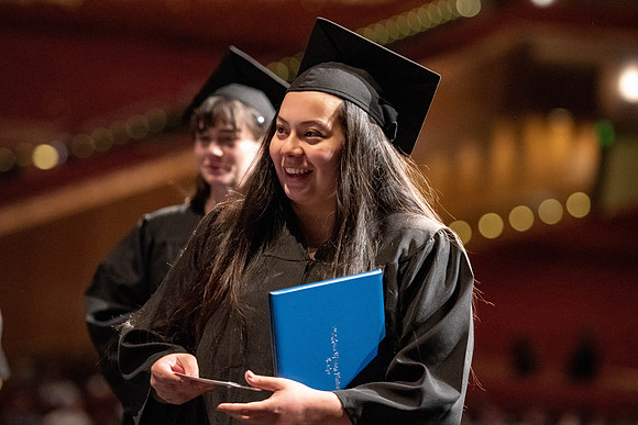 Graduates walk across the stage at the BYU-Idaho Center as they accept their diplomas for Agriculture and Life Science.