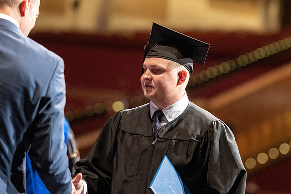 Graduates walk across the stage at the BYU-Idaho Center as they accept their diplomas for Agriculture and Life Science.