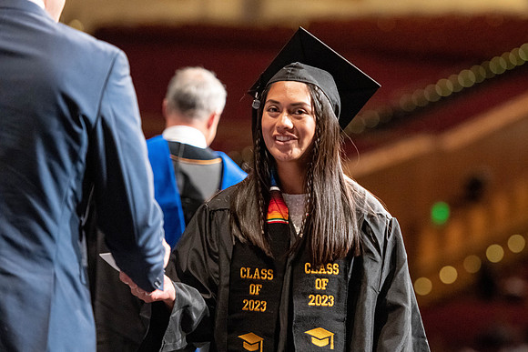 Graduates walk across the stage at the BYU-Idaho Center as they accept their diplomas for Agriculture and Life Science.