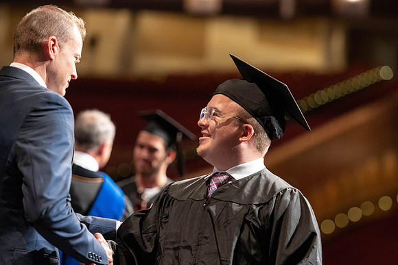 Graduates walk across the stage at the BYU-Idaho Center as they accept their diplomas for Agriculture and Life Science.