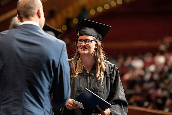 Graduates walk across the stage at the BYU-Idaho Center as they accept their diplomas for Agriculture and Life Science.